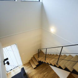 高窓から光の届く、視線を縦に通わせる吹き抜け